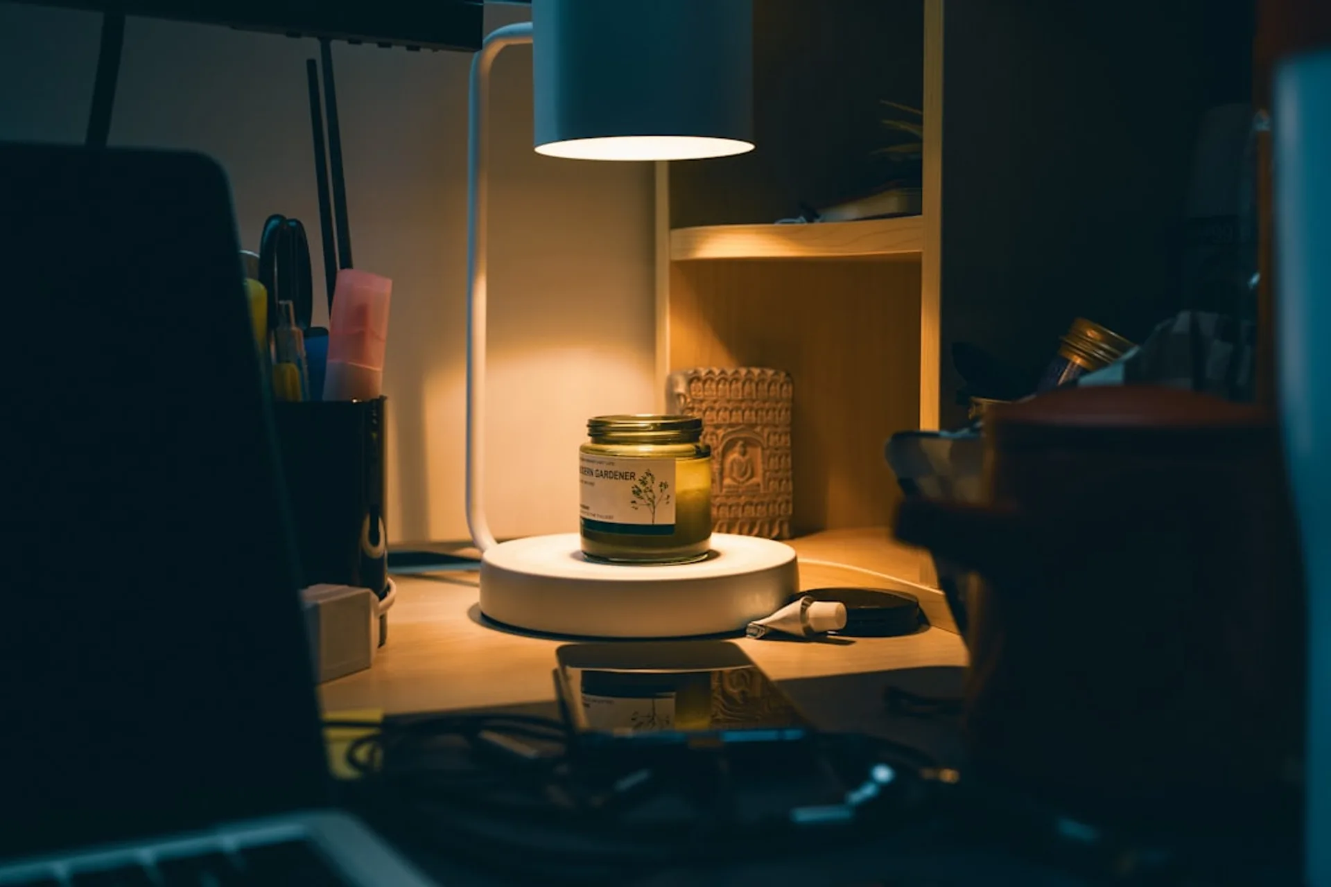 A minimal workspace with headphones and a laptop, soft ambient lighting suggesting focused work