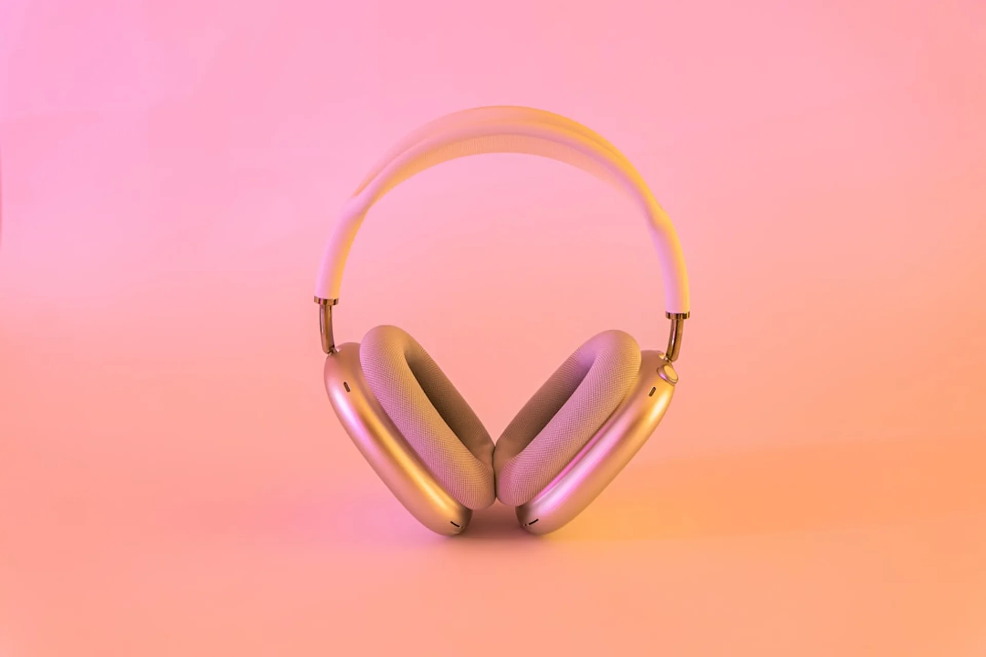Headphones resting on a pillow with soft lighting