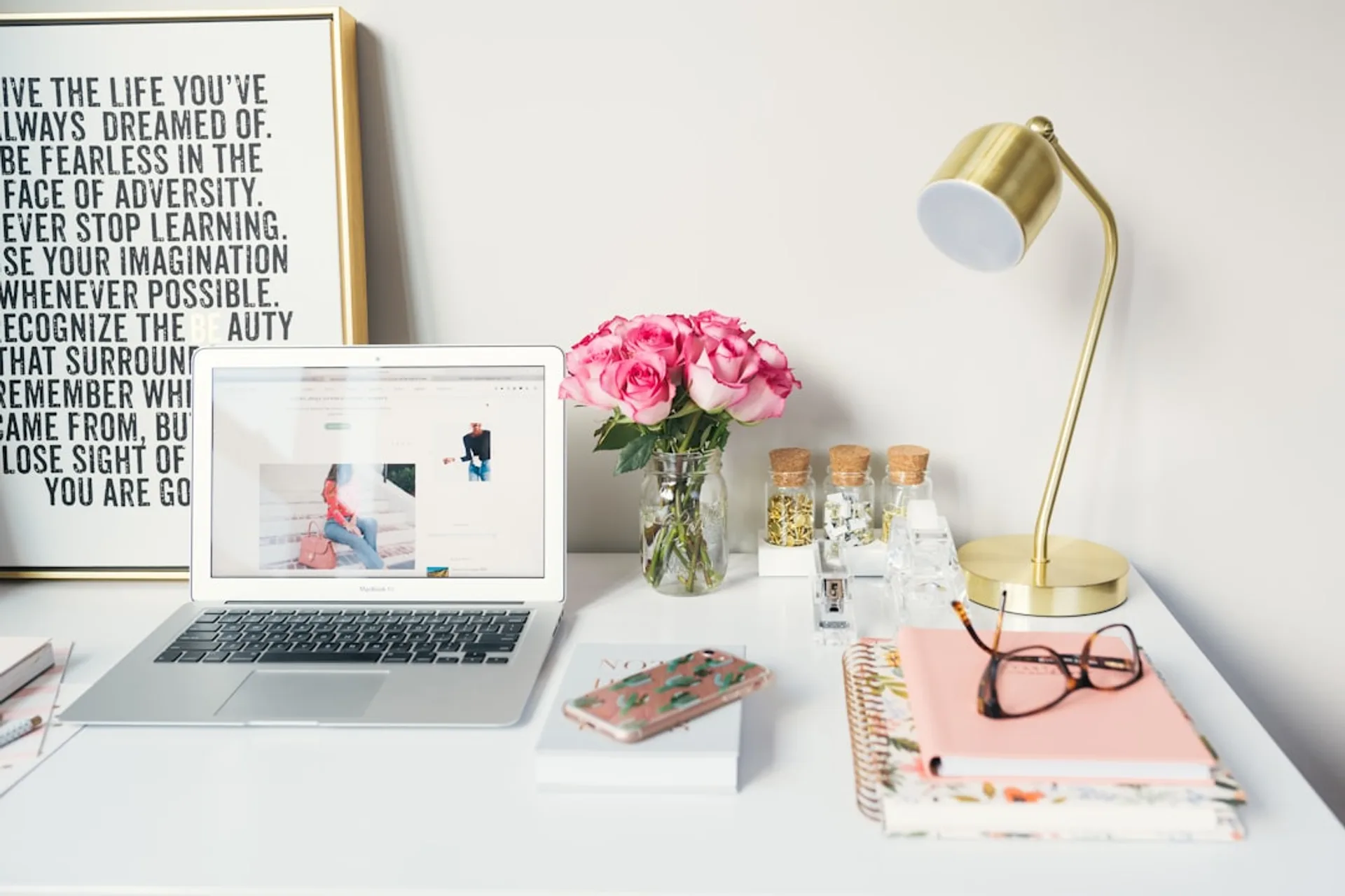 A focused workspace illuminated by a warm desk lamp, with headphones resting on a notebook