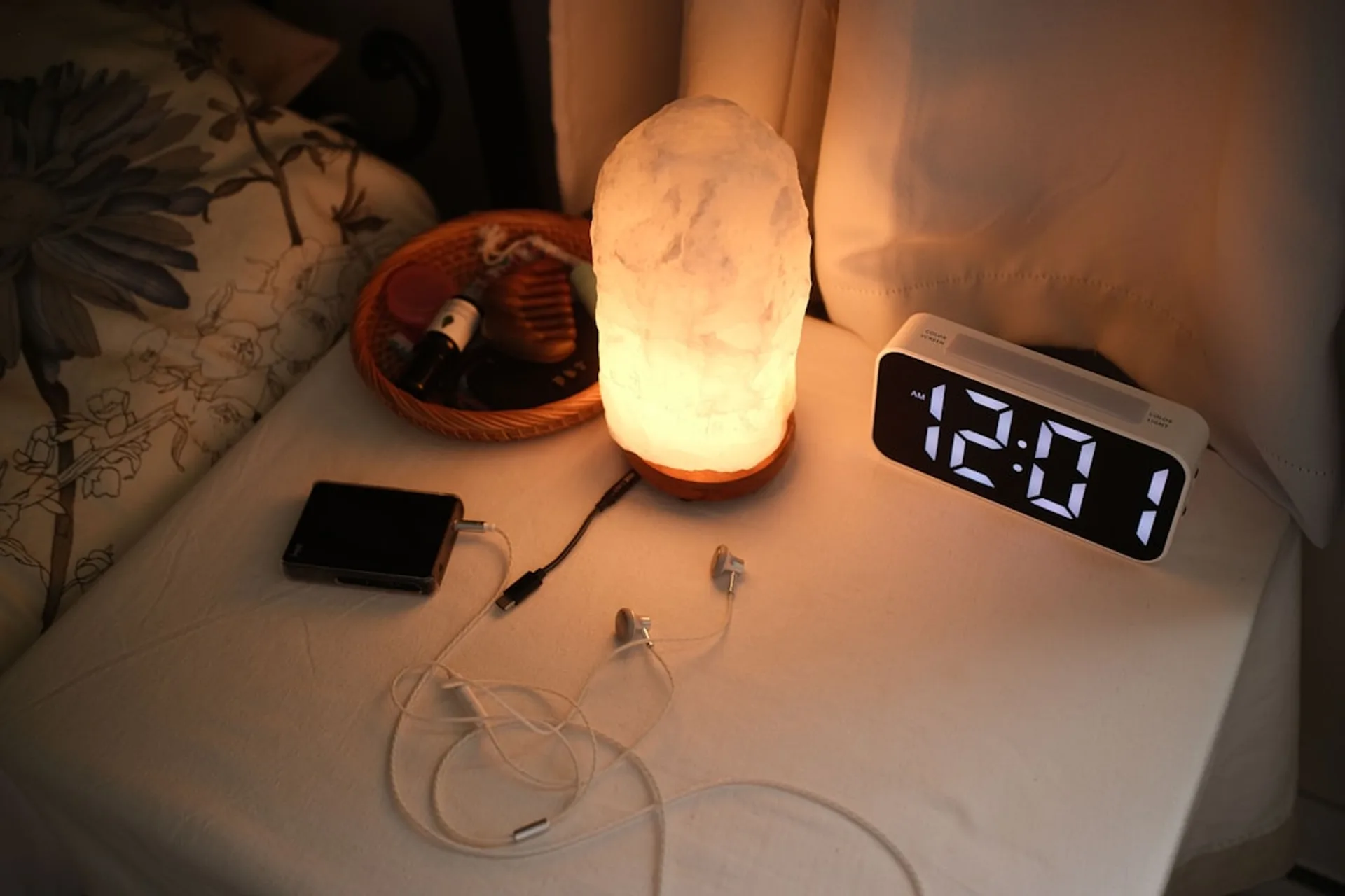 White noise machine on a nightstand with soft ambient lighting