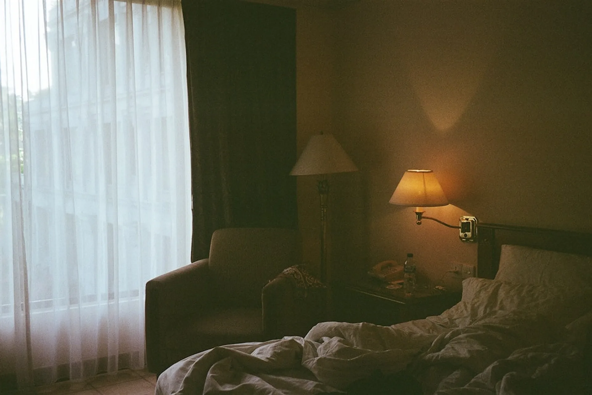 Dim bedroom at night with soft ambient light, suggesting a calm space for sleep sounds